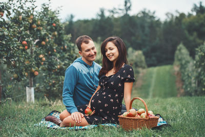 Young couple kissing against clear sky