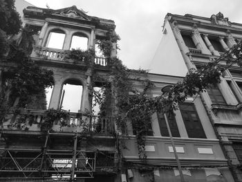 Low angle view of abandoned building against sky