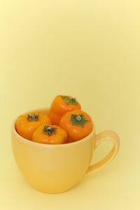 Close-up of orange fruit against white background