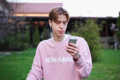 Teenage girl using mobile phone outdoors