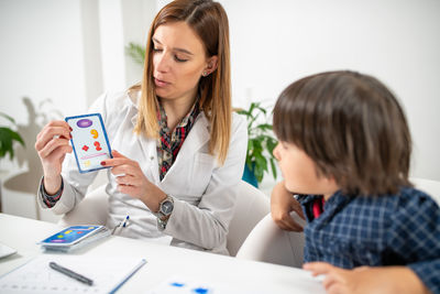 Female doctor examining patient at home