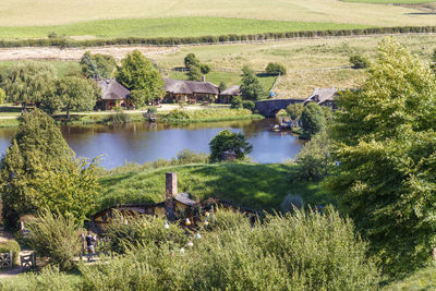 Scenic view of lake by trees and houses