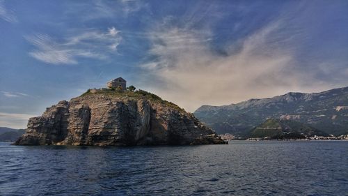 Scenic view of sea and mountains against sky