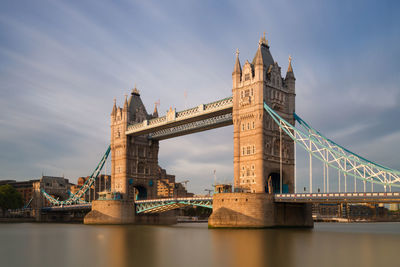 View of bridge over river against cloudy sky