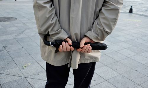 Low section of man walking on street