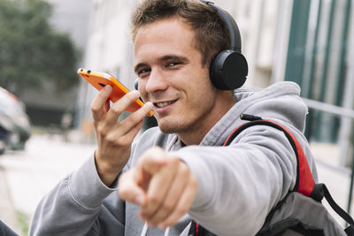Portrait of man talking on phone outdoors
