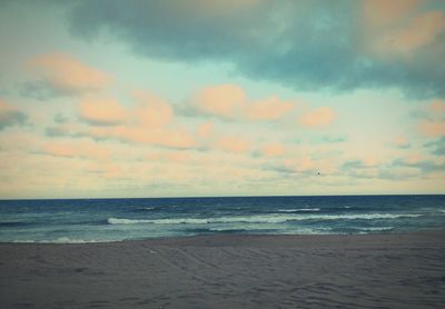 Scenic view of sea against cloudy sky