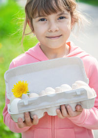 Portrait of smiling woman holding gift