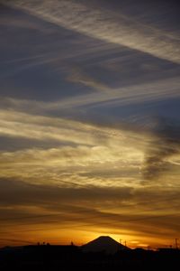 Silhouette of landscape against cloudy sky