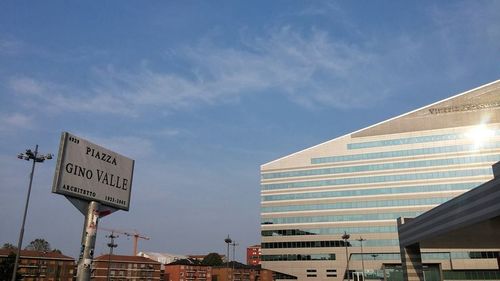 Low angle view of modern building against cloudy sky