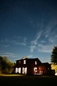 Low angle view of buildings against sky at night