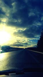 Car on road against sky during sunset