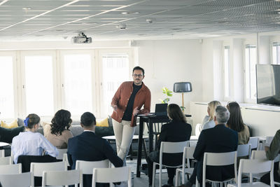 Group of business people attending presentation during conference