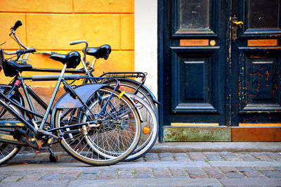 Bicycles on sidewalk against building