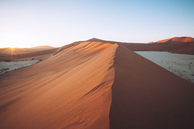 Scenic view of desert against clear sky