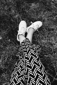 Low section of woman standing on grass