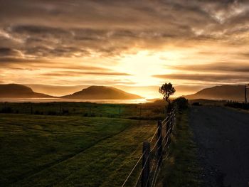 Scenic view of field against sky during sunset