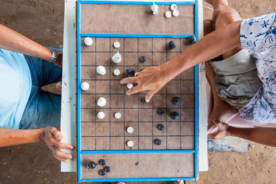 Low section of man playing with cropped hands