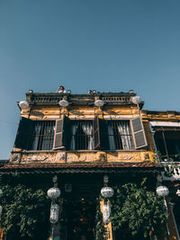 Low angle view of building against clear blue sky