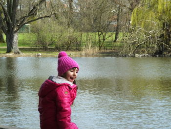 Smiling boy standing in lake during winter