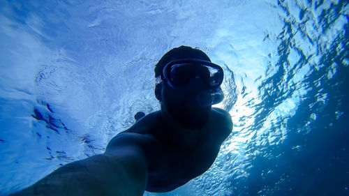 Low angle view of man swimming in sea