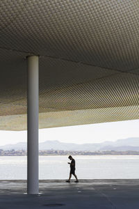 Man standing by sea against sky