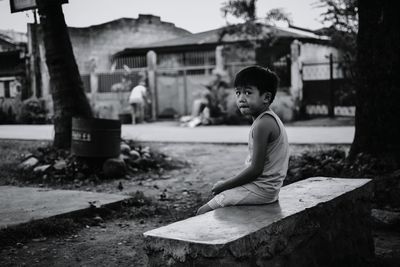 Boy sitting outdoors