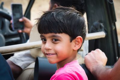 Close-up portrait of boy traveling in vehicle