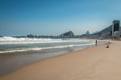 Scenic view of beach against clear sky