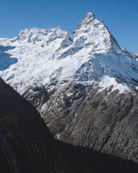 Scenic view of snowcapped mountains against clear sky