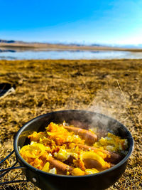 Close-up of food on beach against sky