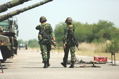 Army soldiers walking on road in city