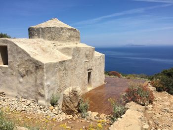 Old ruins of building against blue sky