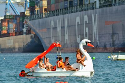 People on boat in city