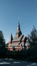 View of buildings against clear blue sky