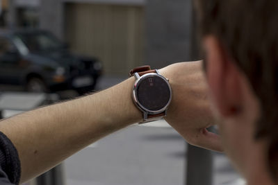 Cropped image of man checking time