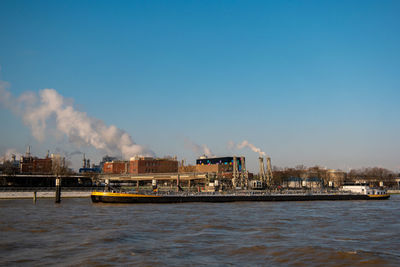 Commercial dock by sea against sky in city