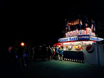 Illuminated ferris wheel at night