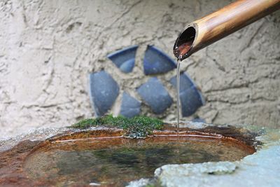 Close-up of water fountain against wall