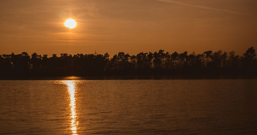 Scenic view of lake against sky during sunset