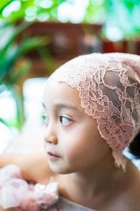 Close-up portrait of cute girl looking away