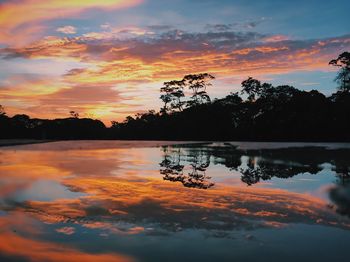 Scenic view of lake against orange sky