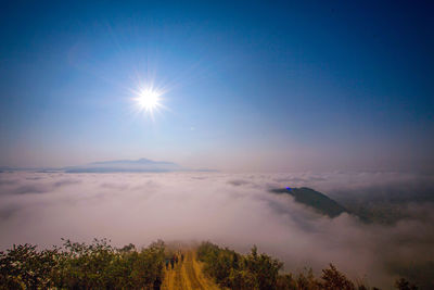 Scenic view of bright sun against sky during sunset