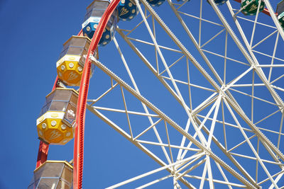 Carousel. ferris wheel on a blue background. carriages of the big wheel.