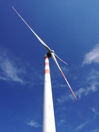 Low angle view of windmill against blue sky