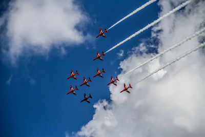 Low angle view of airshow against sky