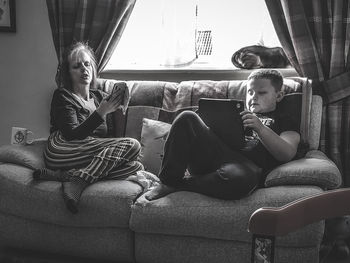 Boy sitting on sofa at home