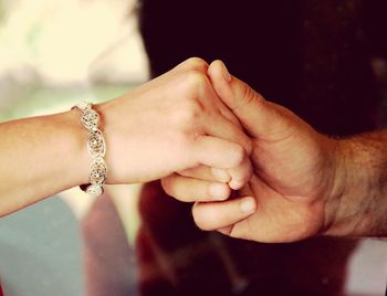 Close-up of couple holding hands