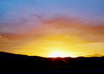 Scenic view of silhouette mountains against sky during sunset