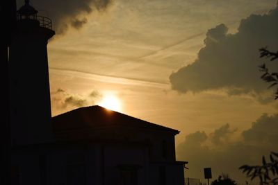 Low angle view of silhouette building against sky during sunset